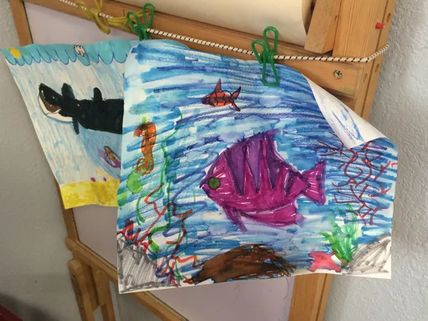 A bright watercolor painting of a fish made in a therapy session