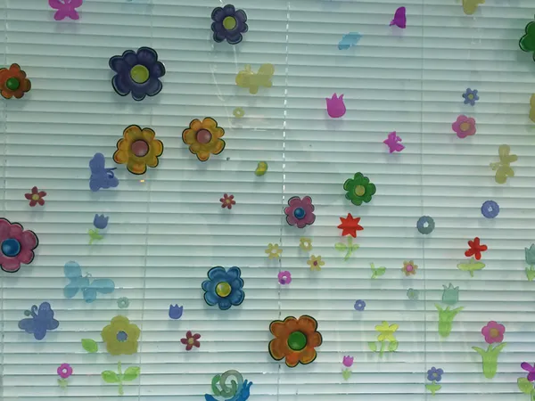 Paper flowers decorating a window in the therapy room